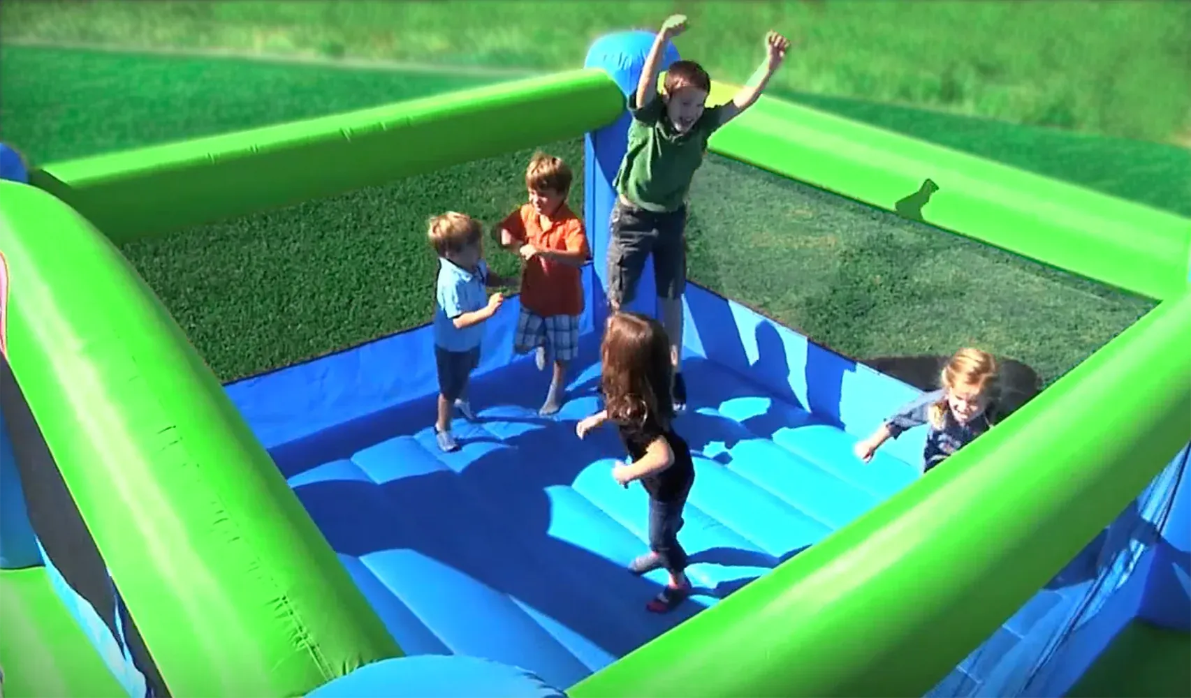 Children's inflatable bounce house set up in a park.
